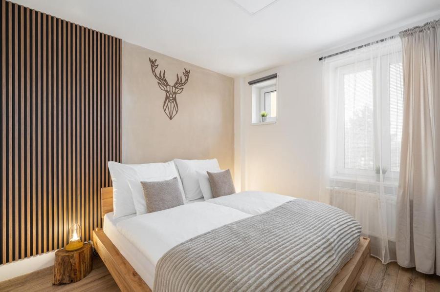 Bedroom with a large double bed and slatted wood wall